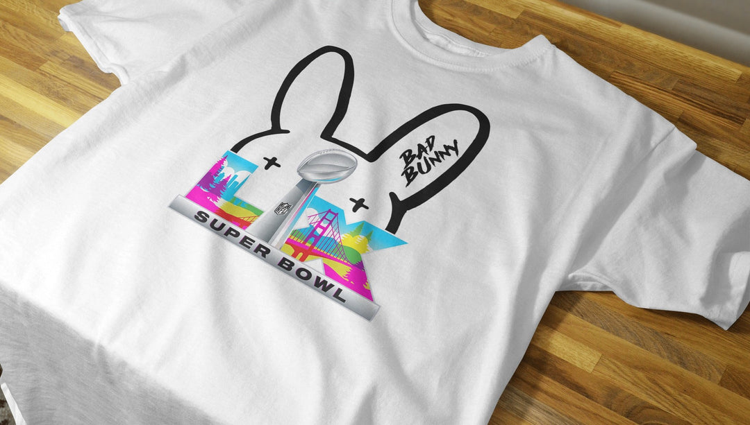 White t-shirt with colorful graphic design on a wooden surface