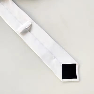 White sublimation necktie showcasing a unique square tip, perfect for custom DTF designs and vibrant printing.