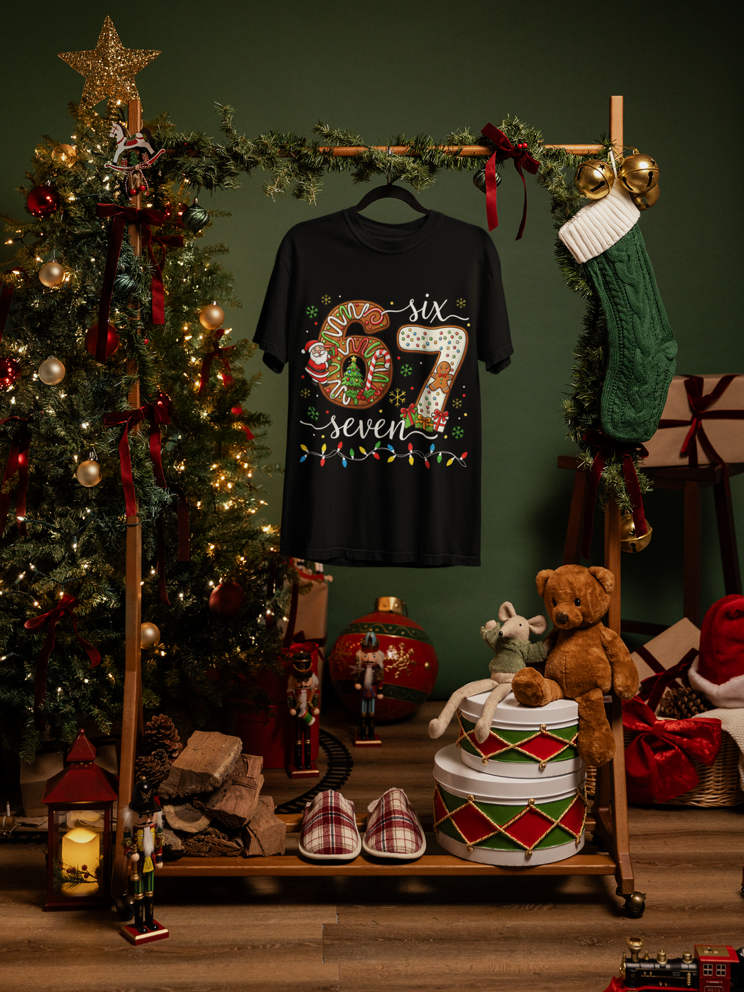 Black t-shirt with colorful design hanging on a wooden stand against a festive background with Christmas tree and decorations.